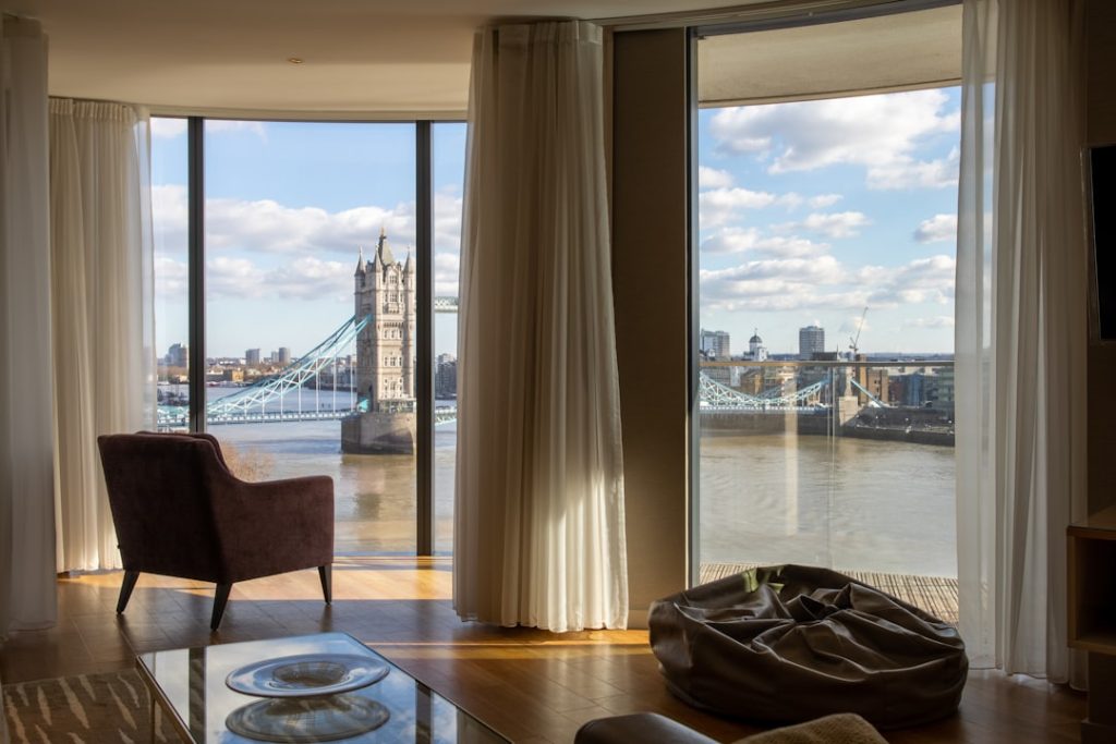 a-living-room-filled-with-furniture-and-a-large-window-l61ekz4ott4